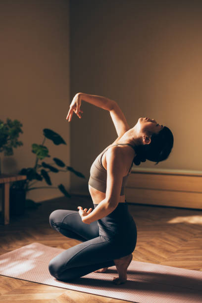 istock Woman Practicing Yoga Pose Indoors On A Sunny Day 2170148095