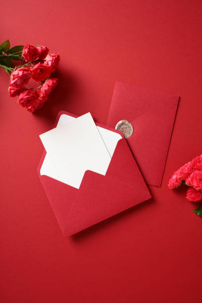 istock Elegant red envelopes with roses on rich red background. Flat lay, top view, copy space. 2170148227