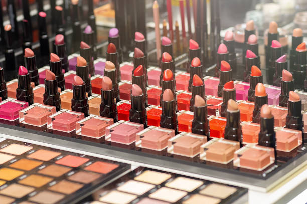 istock Different lipstick colors  and eye shadows in a cosmetics store 2170148618