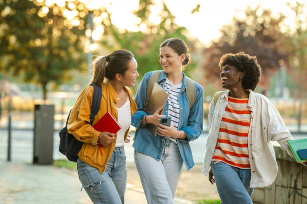 istock Diverse group of students walking with books in urban setting 2170150168
