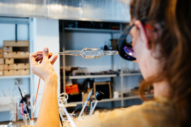 An Artisan Meticulously Inspecting Glasswork in Their Workshop