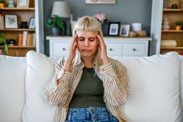 istock Young woman suffering from headache 2170150284