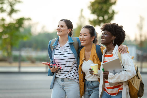 istock Diverse group of students walking with books in urban setting 2170151168