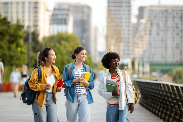 istock Diverse group of students walking with books in urban setting 2170151326