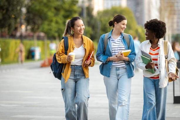 istock Diverse group of students walking with books in urban setting 2170151365