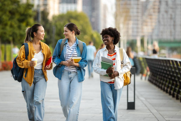 istock Diverse group of students walking with books in urban setting 2170151484
