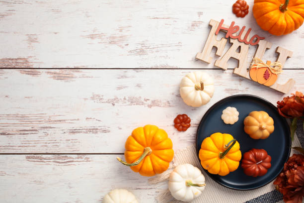 istock Flat lay composition with plaid, plate with pumpkins, Hello Fall message on wooden desk table top view. 2170153102