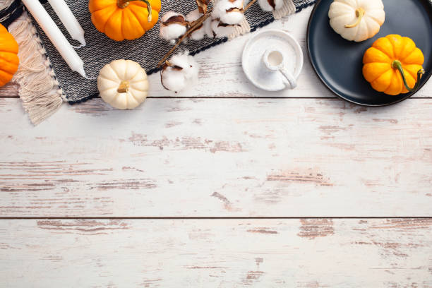 istock Flat lay composition with plaid, pumpkins, autumn decor on white wooden desk table. Cozy fall atmosphere. 2170153182