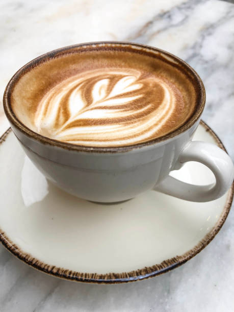 istock cappuccino coffee cup with latte art on table 2170153328
