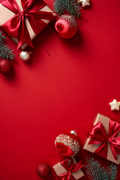 istock Christmas poster, vertical banner, party invitation template. Flat lay composition with luxury gifts, fir branches, balls on red background. 2170154769