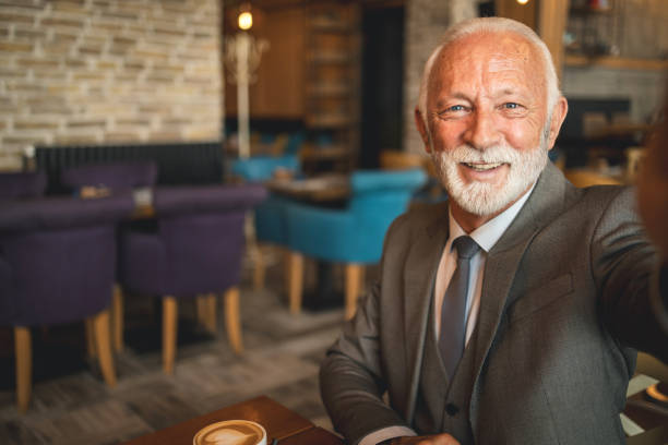 istock Elderly man making a selfie in a cozy coffee shop 2170156237