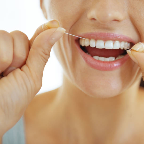 istock Closeup on young woman using dental floss 2170156307