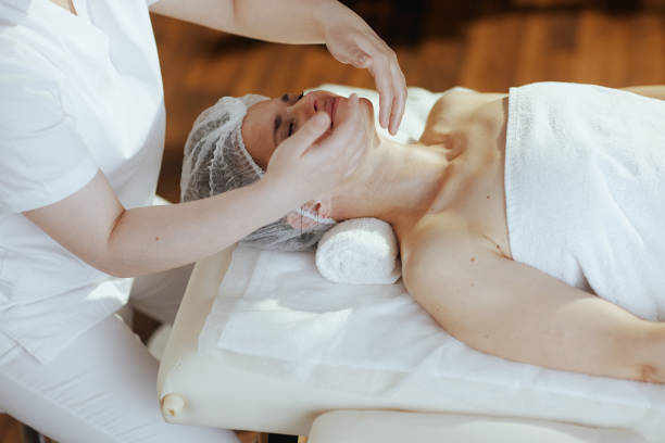 istock medical massage therapist massaging clients face 2170156957