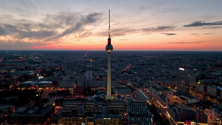 Aerial video shows a vibrant cityscape with a majestic tower famous places architectural landmarks TV Tower, Alexanderplatz at night. Berlin, Germany