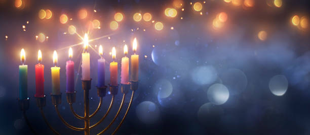 istock Hanukkah Menorah - Burning Candles With Glittering In Abstract Defocused Background 2170161315