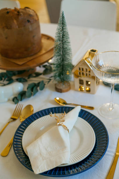 istock Stylish light Christmas table setting with golden cutlery. Festive feasts. Decorations on the New Year's table. 2170165251