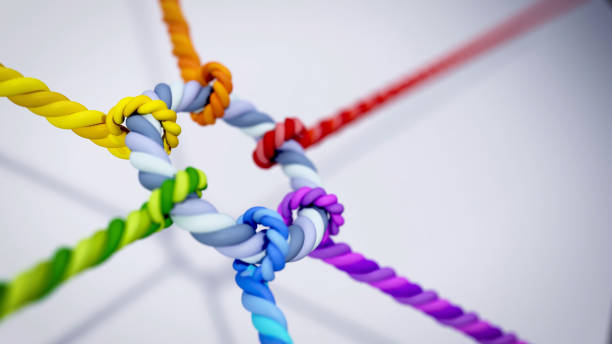 A vibrant array of colored ropes twists and knots together, showcasing intricate techniques and craftsmanship in a hands-on workshop setting.