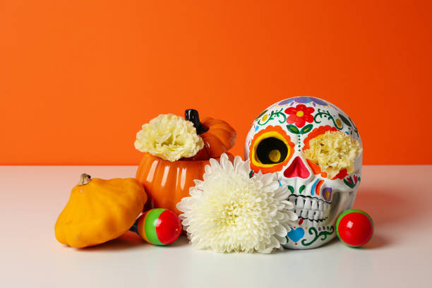istock Mexican skull, zucchini and flowers on orange background 2170169687