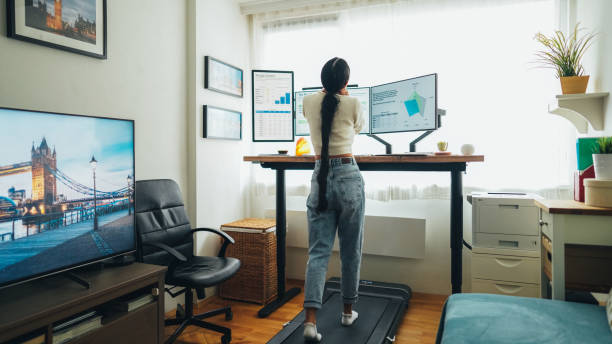 istock Woman at home office is walking on under desk treadmill 2170171271
