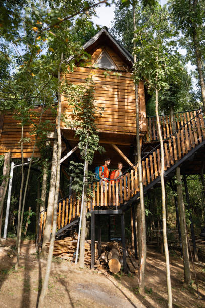 Young Caucasian couple, boyfriend and girlfriend, exploring the tree house, during their weekend getaway