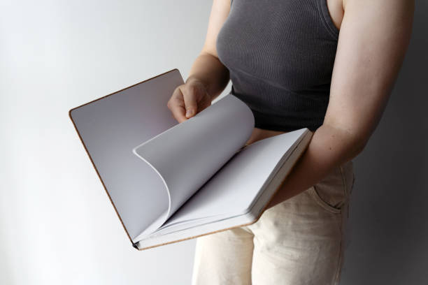 istock Woman flipping through sketchbook pages casually 2170177505