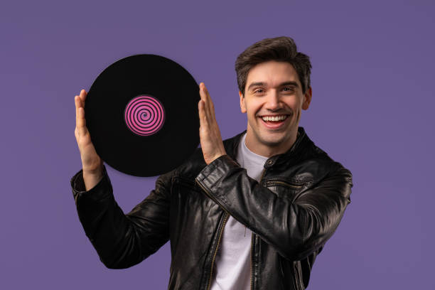 istock Handsome Man Dancing Vinyl Record Disc On Violet. Hobby, Music Lover, Collection 2170178021