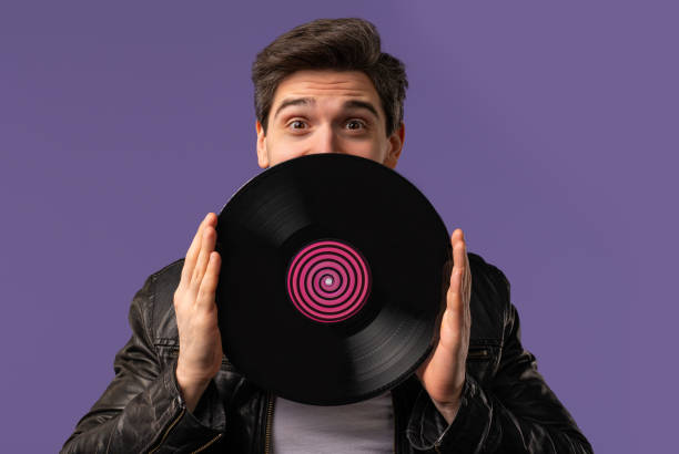 istock Handsome Man Dancing Vinyl Record Disc On Violet. Hobby, Music Lover, Collection 2170178024