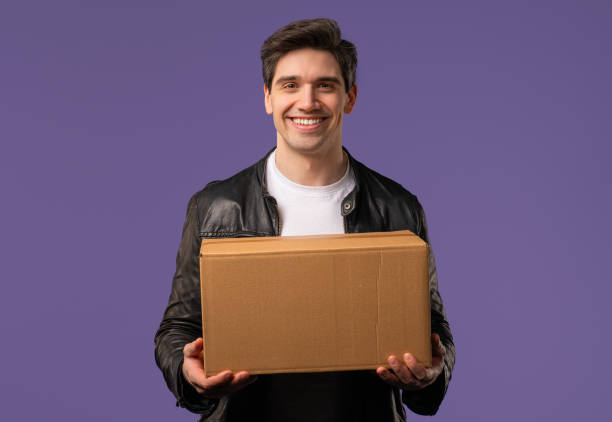 istock Excited smiling man, online shopping consumer received cardboard order parcel box, desired purchase. Home courier delivery service. Sale, discounts 2170178059