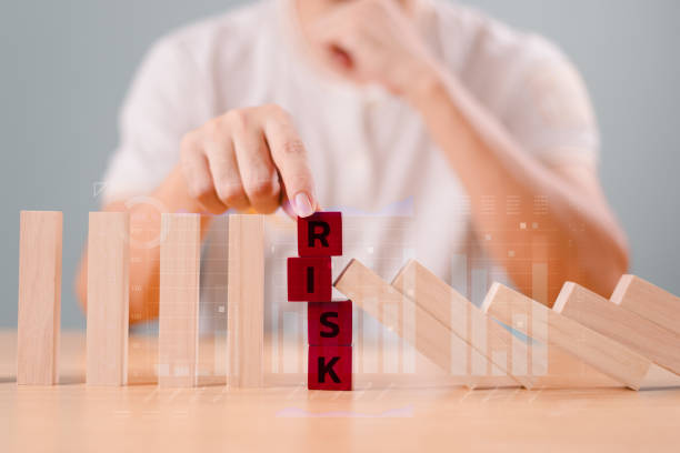 istock Risk assessment crisis concept. Financial analysis solution for real estate business management. Hand stop economic risk. Risk word on wooden block, domino crisis reduce effect. Insurance security 2170179023
