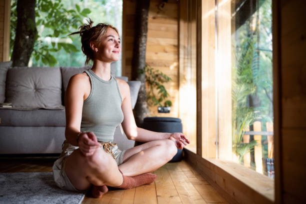 istock Young Caucasian woman mediating, from the tree house 2170179687