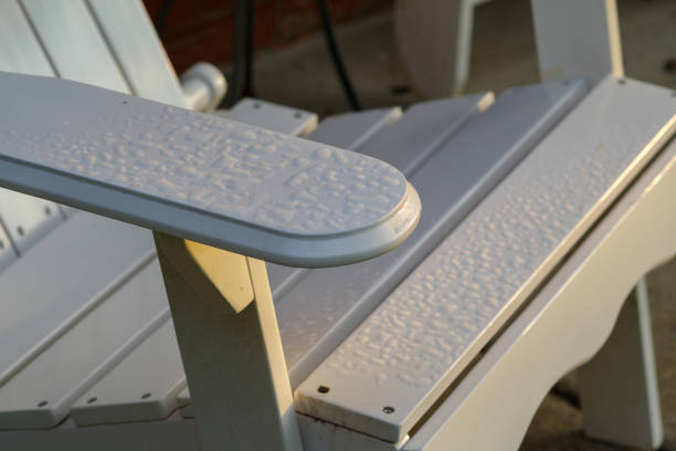 istock Dawn light and morning dew on Adirondack chair 2170179845