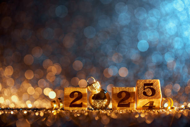 istock Wooden Blocks Displaying 2025 with a Silver Ornament on a Glittering Bokeh Background 2170180873