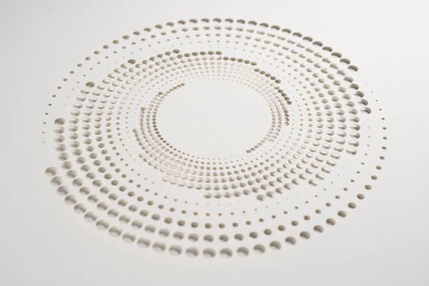 Native image size: 7952 x 5304. This minimalist artwork features concentric circles composed of perforated dots of varying sizes on a clean white background. The precision of the cut design creates a subtle play of light and shadow, enhancing the simplicity of the composition while adding depth and texture to the piece.
