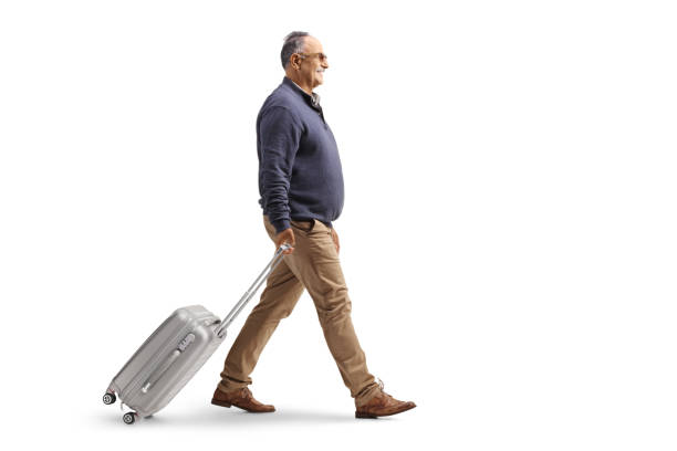 istock Full length profile shot of a mature man walking and pulling a suitcase 2170184013