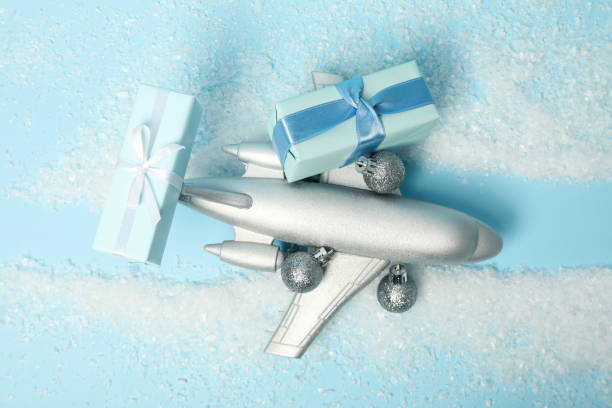 istock Airplane with gifts and snow on a blue background. 2170186862