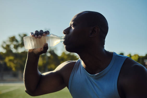 istock Athletic man drinks still or mineral water outdoors 2170187220