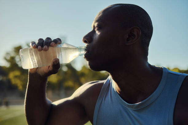 istock Athletic man drinks still or mineral water outdoors 2170187223