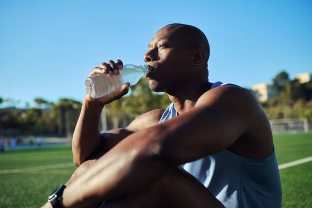istock Athletic man drinks still or mineral water outdoors 2170187224