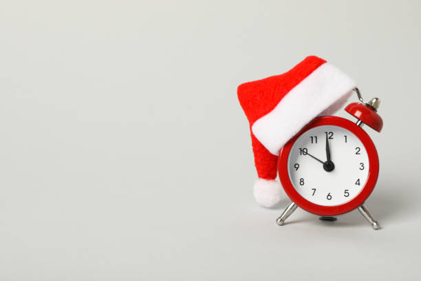 istock A clock with a Santa hat with a New Year's decoration. 2170188032