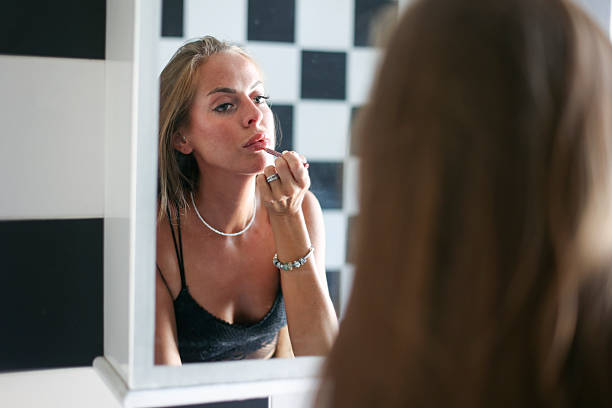 istock Young woman applying make-up 2170188795