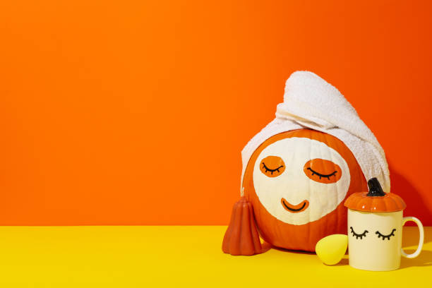 istock Skin and face care concept - pumpkin with face mask 2170189122