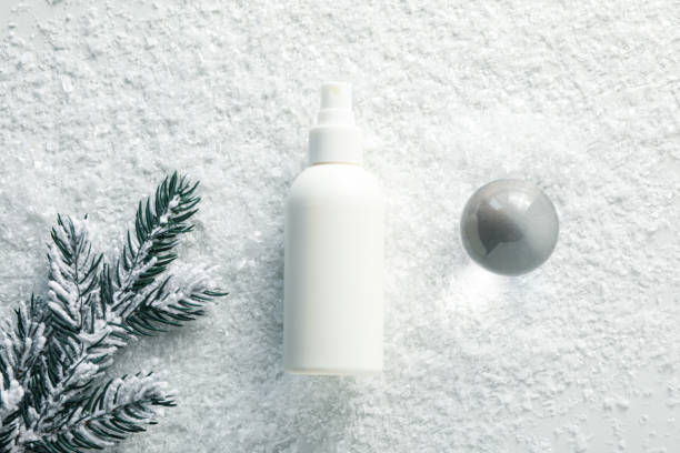 istock Cosmetic bottle and fir branch on light background, top view 2170191167