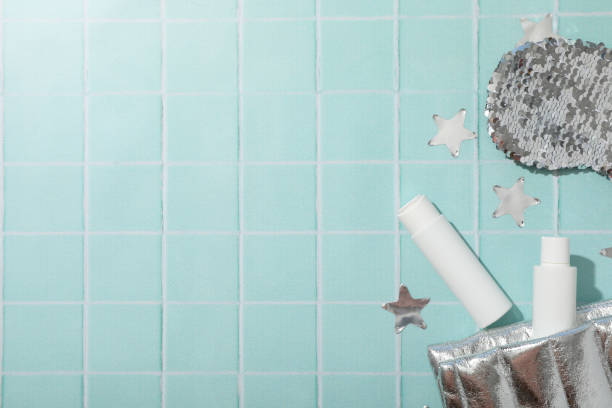 Lip balms and accessories on blue background, space for text