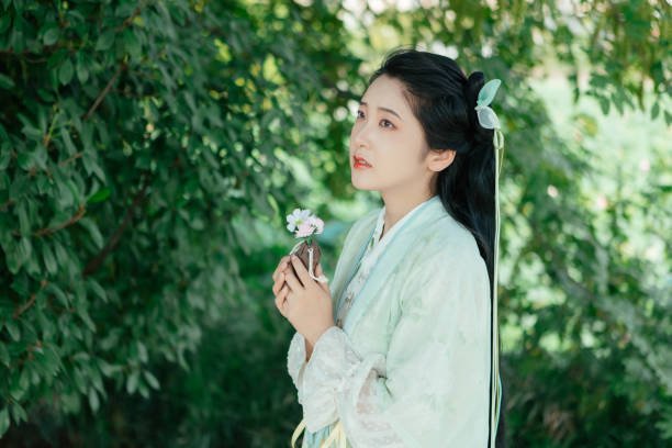 Asian girl in a beautiful red kimono in the middle of nature in canyon