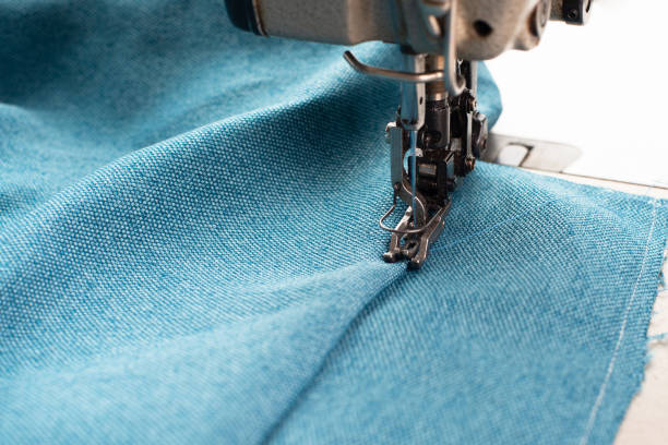 istock Industrial sewing machine with blue fabric, working place, manufacture for clothes, handmade, small local business, textile industry 2170193364