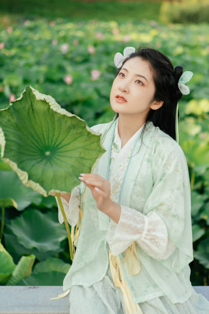 istock A Hanfu beauty playing outdoors by the lotus pond in summer 2170193382