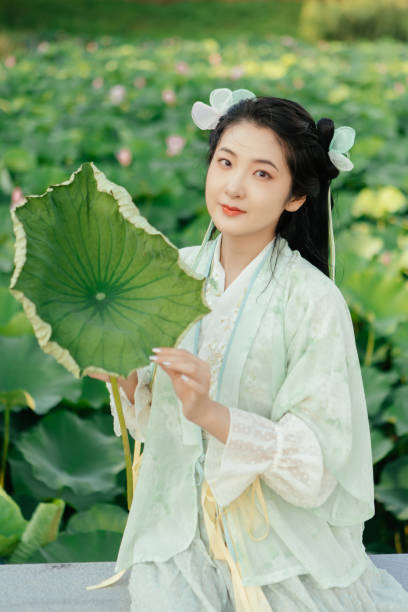 istock A Hanfu beauty playing outdoors by the lotus pond in summer 2170193441