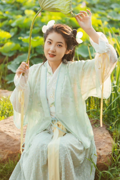 istock A Hanfu beauty playing outdoors by the lotus pond in summer 2170193664