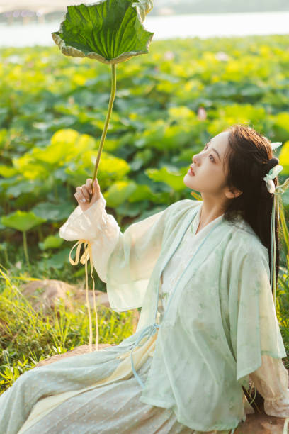 istock A Hanfu beauty playing outdoors by the lotus pond in summer 2170193708