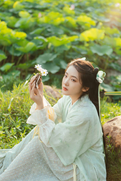 istock A Hanfu beauty playing outdoors by the lotus pond in summer 2170193792